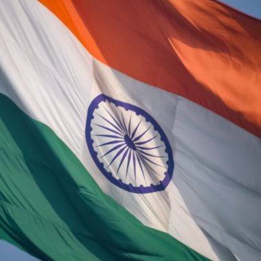 India flag flying high at Connaught Place with pride in blue sky, India flag fluttering, Indian Flag on Independence Day and Republic Day of India, tilt up shot, Waving Indian flag, Har Ghar Tiranga