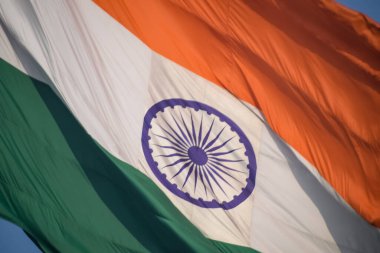 India flag flying high at Connaught Place with pride in blue sky, India flag fluttering, Indian Flag on Independence Day and Republic Day of India, tilt up shot, Waving Indian flag, Har Ghar Tiranga