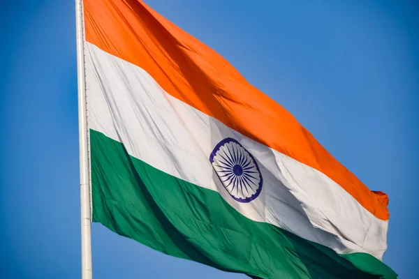 stock image India flag flying high at Connaught Place with pride in blue sky, India flag fluttering, Indian Flag on Independence Day and Republic Day of India, tilt up shot, Waving Indian flag, Har Ghar Tiranga