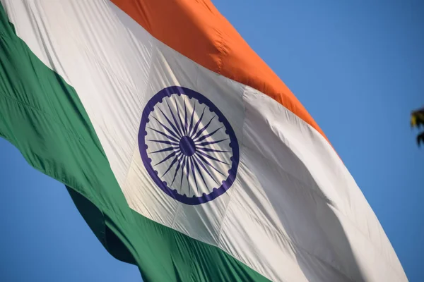 stock image India flag flying high at Connaught Place with pride in blue sky, India flag fluttering, Indian Flag on Independence Day and Republic Day of India, tilt up shot, Waving Indian flag, Har Ghar Tiranga