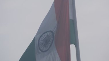 India flag flying high at Connaught Place with pride in blue sky, India flag fluttering, Indian Flag on Independence Day and Republic Day of India, tilt up shot, Waving Indian flag, Har Ghar Tiranga