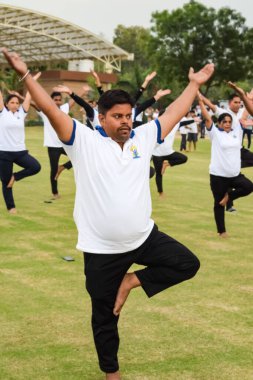 Yeni Delhi, Hindistan, 21 Haziran 2023 - Uluslararası Yoga Günü 'nde Delhi' deki Yamuna Spor Kompleksi 'nde grup Yoga egzersiz oturumu, kriket stadyumunda yoga derslerine katılan büyük bir grup yetişkin