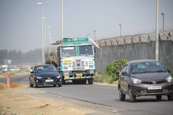 stock image New Delhi, India - April 16, 2023 - View of Vehicles passing through the main road near Indra Gandhi International Airport Delhi at Dwarka link road