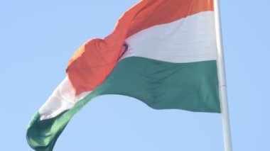 India flag flying high at Connaught Place with pride in blue sky, India flag fluttering, Indian Flag on Independence Day and Republic Day of India, tilt up shot, Waving Indian flag, Har Ghar Tiranga
