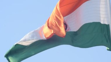 India flag flying high at Connaught Place with pride in blue sky, India flag fluttering, Indian Flag on Independence Day and Republic Day of India, tilt up shot, Waving Indian flag, Har Ghar Tiranga