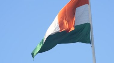India flag flying high at Connaught Place with pride in blue sky, India flag fluttering, Indian Flag on Independence Day and Republic Day of India, tilt up shot, Waving Indian flag, Har Ghar Tiranga