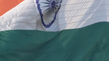 India flag flying high at Connaught Place with pride in blue sky, India flag fluttering, Indian Flag on Independence Day and Republic Day of India, tilt up shot, Waving Indian flag, Har Ghar Tiranga