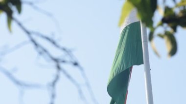 India flag flying high at Connaught Place with pride in blue sky, India flag fluttering, Indian Flag on Independence Day and Republic Day of India, tilt up shot, Waving Indian flag, Har Ghar Tiranga