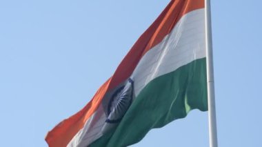 India flag flying high at Connaught Place with pride in blue sky, India flag fluttering, Indian Flag on Independence Day and Republic Day of India, tilt up shot, Waving Indian flag, Har Ghar Tiranga