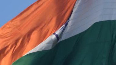 India flag flying high at Connaught Place with pride in blue sky, India flag fluttering, Indian Flag on Independence Day and Republic Day of India, tilt up shot, Waving Indian flag, Har Ghar Tiranga