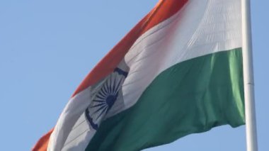 India flag flying high at Connaught Place with pride in blue sky, India flag fluttering, Indian Flag on Independence Day and Republic Day of India, tilt up shot, Waving Indian flag, Har Ghar Tiranga