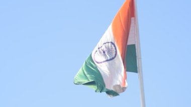 India flag flying high at Connaught Place with pride in blue sky, India flag fluttering, Indian Flag on Independence Day and Republic Day of India, tilt up shot, Waving Indian flag, Har Ghar Tiranga