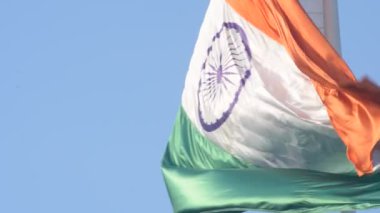 India flag flying high at Connaught Place with pride in blue sky, India flag fluttering, Indian Flag on Independence Day and Republic Day of India, tilt up shot, Waving Indian flag, Har Ghar Tiranga