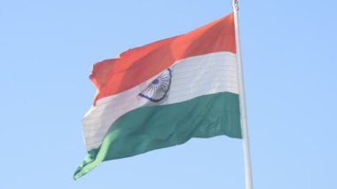 India flag flying high at Connaught Place with pride in blue sky, India flag fluttering, Indian Flag on Independence Day and Republic Day of India, tilt up shot, Waving Indian flag, Har Ghar Tiranga