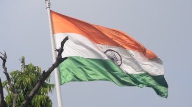India flag flying high at Connaught Place with pride in blue sky, India flag fluttering, Indian Flag on Independence Day and Republic Day of India, tilt up shot, Waving Indian flag, Har Ghar Tiranga