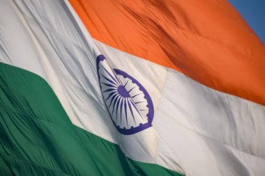 India flag flying high at Connaught Place with pride in blue sky, India flag fluttering, Indian Flag on Independence Day and Republic Day of India, tilt up shot, Waving Indian flag, Har Ghar Tiranga