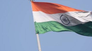 India flag flying high at Connaught Place with pride in blue sky, India flag fluttering, Indian Flag on Independence Day and Republic Day of India, tilt up shot, Waving Indian flag, Har Ghar Tiranga