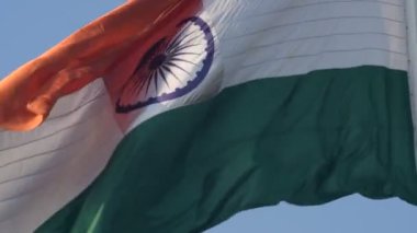 India flag flying high at Connaught Place with pride in blue sky, India flag fluttering, Indian Flag on Independence Day and Republic Day of India, tilt up shot, Waving Indian flag, Har Ghar Tiranga