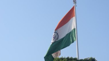 India flag flying high at Connaught Place with pride in blue sky, India flag fluttering, Indian Flag on Independence Day and Republic Day of India, tilt up shot, Waving Indian flag, Har Ghar Tiranga