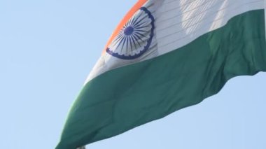 India flag flying high at Connaught Place with pride in blue sky, India flag fluttering, Indian Flag on Independence Day and Republic Day of India, tilt up shot, Waving Indian flag, Har Ghar Tiranga