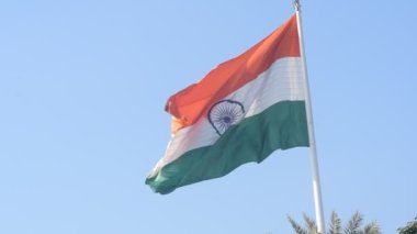 India flag flying high at Connaught Place with pride in blue sky, India flag fluttering, Indian Flag on Independence Day and Republic Day of India, tilt up shot, Waving Indian flag, Har Ghar Tiranga