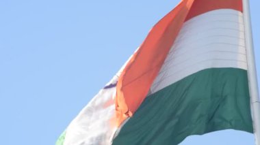 India flag flying high at Connaught Place with pride in blue sky, India flag fluttering, Indian Flag on Independence Day and Republic Day of India, tilt up shot, Waving Indian flag, Har Ghar Tiranga