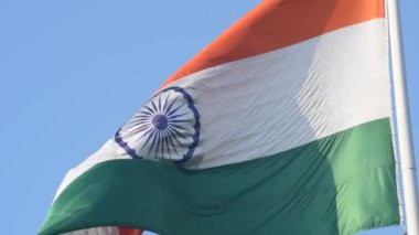 India flag flying high at Connaught Place with pride in blue sky, India flag fluttering, Indian Flag on Independence Day and Republic Day of India, tilt up shot, Waving Indian flag, Har Ghar Tiranga