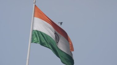 India flag flying high at Connaught Place with pride in blue sky, India flag fluttering, Indian Flag on Independence Day and Republic Day of India, tilt up shot, Waving Indian flag, Har Ghar Tiranga