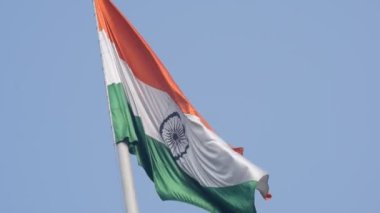 India flag flying high at Connaught Place with pride in blue sky, India flag fluttering, Indian Flag on Independence Day and Republic Day of India, tilt up shot, Waving Indian flag, Har Ghar Tiranga