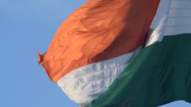 India flag flying high at Connaught Place with pride in blue sky, India flag fluttering, Indian Flag on Independence Day and Republic Day of India, tilt up shot, Waving Indian flag, Har Ghar Tiranga