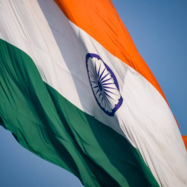 India flag flying high at Connaught Place with pride in blue sky, India flag fluttering, Indian Flag on Independence Day and Republic Day of India, tilt up shot, Waving Indian flag, Har Ghar Tiranga