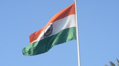 India flag flying high at Connaught Place with pride in blue sky, India flag fluttering, Indian Flag on Independence Day and Republic Day of India, tilt up shot, Waving Indian flag, Har Ghar Tiranga