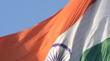 India flag flying high at Connaught Place with pride in blue sky, India flag fluttering, Indian Flag on Independence Day and Republic Day of India, tilt up shot, Waving Indian flag, Har Ghar Tiranga