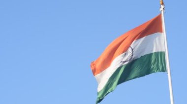 India flag flying high at Connaught Place with pride in blue sky, India flag fluttering, Indian Flag on Independence Day and Republic Day of India, tilt up shot, Waving Indian flag, Har Ghar Tiranga