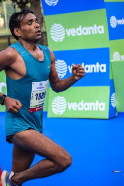 Yeni Delhi, Hindistan - 16 Ekim 2022 - Bitmek üzere olan maraton katılımcılarının bitiş çizgisini geçmek üzere olan Delhi Yarı Maratonu 2022