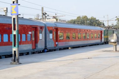 Amritsar, India, April 20 2023 - Indian railway train at Amritsar railway station platform during morning time, Colourful train at Amritsar, Punjab railway station clipart