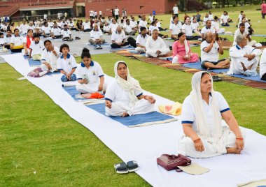 Yeni Delhi, Hindistan, 21 Haziran 2023 - Uluslararası Yoga Günü 'nde Delhi' deki Yamuna Spor Kompleksi 'nde grup Yoga egzersiz oturumu, kriket stadyumunda yoga derslerine katılan büyük bir grup yetişkin