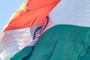 India flag flying high at Connaught Place with pride in blue sky, India flag fluttering, Indian Flag on Independence Day and Republic Day of India, tilt up shot, Waving Indian flag, Har Ghar Tiranga