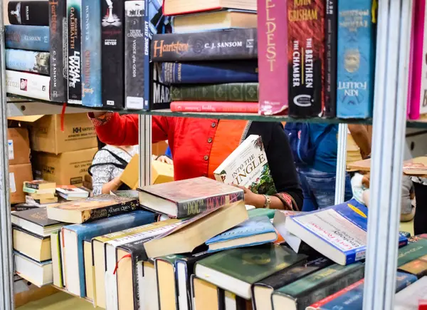 stock image New Delhi, India, September 09 2023 - Variety of Books on shelf inside a book-stall at Delhi International Book Fair, Selection of books on display in Annual Book Fair.