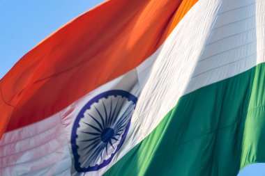 India flag flying high at Connaught Place with pride in blue sky, India flag fluttering, Indian Flag on Independence Day and Republic Day of India, tilt up shot, Waving Indian flag, Har Ghar Tiranga