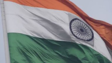 India flag flying high at Connaught Place with pride in blue sky, India flag fluttering, Indian Flag on Independence Day and Republic Day of India, tilt up shot, Waving Indian flag, Har Ghar Tiranga