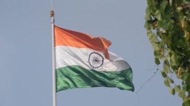 India flag flying high at Connaught Place with pride in blue sky, India flag fluttering, Indian Flag on Independence Day and Republic Day of India, tilt up shot, Waving Indian flag, Har Ghar Tiranga