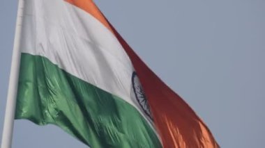 India flag flying high at Connaught Place with pride in blue sky, India flag fluttering, Indian Flag on Independence Day and Republic Day of India, tilt up shot, Waving Indian flag, Har Ghar Tiranga