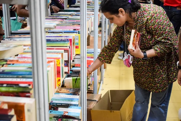 stock image Delhi, India, September 09 2023- Various age group people reading variety of Books on shelf inside a book-stall at Delhi International Book Fair, Selection of books on display in Annual Book Fair