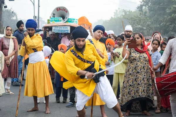 stock image Delhi, India, October 2, 2023 - Sikhs display gatka and martial arts during annual Nagar Kirtan, Traditional, procession on account of birthday of Guru Nanak Dev ji, Nagar Kirtan in East Delhi area