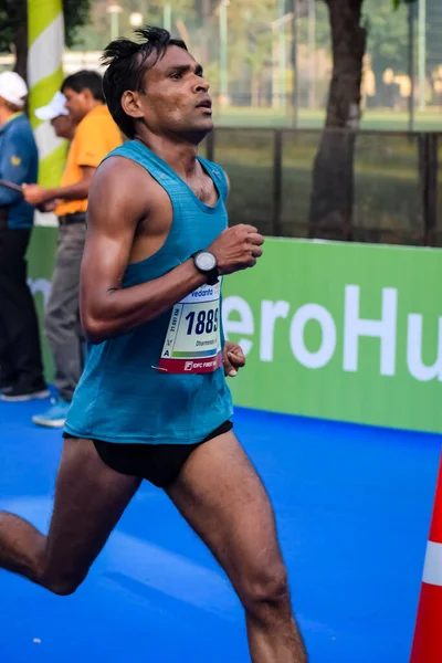 stock image New Delhi, India - October 15 2023 - Vedanta Delhi Half Marathon race after covid in which marathon participants about to cross the finish line, Delhi Half Marathon 2023