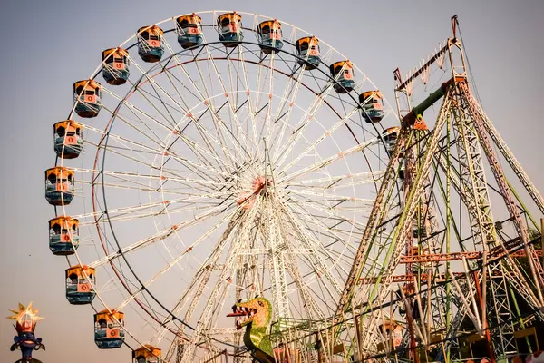 Delhi, Hindistan 'da Dussehra Mela sırasında çok renkli Dev Tekerlek' in yakın çekimi. Dev tekerlek salıncağının alt görüntüsü. Gündüz vakti renkli kamaralı dönme dolap