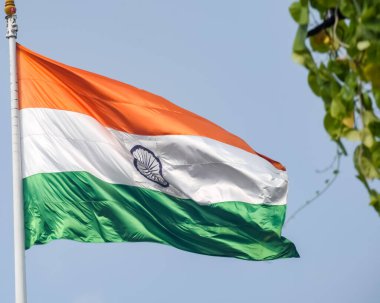 India flag flying high at Connaught Place with pride in blue sky, India flag fluttering, Indian Flag on Independence Day and Republic Day of India, tilt up shot, Waving Indian flag, Har Ghar Tiranga