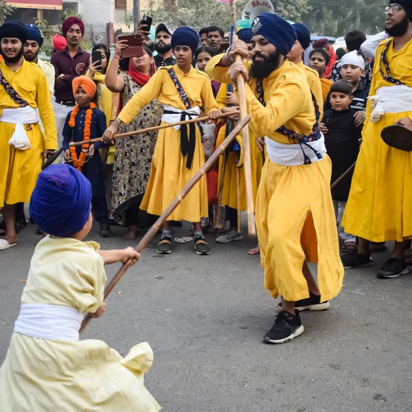 stock image Delhi, India, October 2, 2023 - Sikhs display gatka and martial arts during annual Nagar Kirtan, Traditional, procession on account of birthday of Guru Nanak Dev ji, Nagar Kirtan in East Delhi area