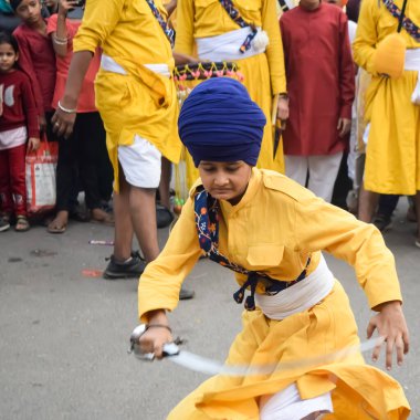 Delhi, Hindistan, 2 Ekim 2023 - Doğu Delhi bölgesinde Guru Nanak Dev, Nagar Kirtan 'ın doğum günü dolayısıyla geleneksel Nagar Kirtan, geleneksel Nagar geçit töreninde Sihler gatka ve dövüş sanatları sergiliyor